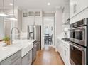 Modern white kitchen with stainless steel appliances and a view into the dining area at 2313 Bucktail Ct, Mount Pleasant, SC 29466