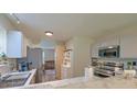 Functional kitchen with stainless steel appliances and modern marble countertops, adjacent to the living room at 2538 Wayne Scott Ct, Charleston, SC 29414