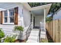 The front entrance features a covered porch with freshly painted stairs, new railings, and a charming baby blue ceiling at 2949 Alabama Dr, North Charleston, SC 29405