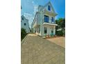 Charming two-story home with white siding, a small balcony, and a welcoming blue front door at 30 Nats Ct, Charleston, SC 29403