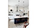 Spacious kitchen with white cabinets, a navy island, stainless appliances, and modern pendant lighting at 30 Nats Ct, Charleston, SC 29403