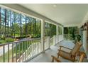 Relaxing porch with rocking chairs and views of the peaceful, tree-lined property at 338 Mcclellan Ave, McClellanville, SC 29458