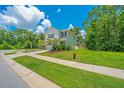 Beautiful two-story home on a corner lot with lush green lawn and trees at 3745 Sawmill Ct, Mount Pleasant, SC 29429