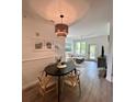 Bright dining area with wood floors, stylish lighting, and a seamless flow to the cozy living space at 400 Bucksley Ln # 301, Charleston, SC 29492