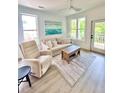Inviting living room with natural light, comfortable seating, ceiling fan, and access to the outdoor balcony at 400 Bucksley Ln # 301, Charleston, SC 29492