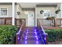 Inviting front entrance featuring a well-lit porch and tasteful landscaping, adding to the home's curb appeal at 4765 Arco Ln, North Charleston, SC 29418