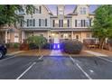 Charming townhome features a traditional facade, well-manicured landscaping, and ample parking at 4765 Arco Ln, North Charleston, SC 29418