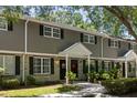 Exterior of the townhome showing a combination of gray siding and brick with black shutters and well-maintained landscaping at 507 Stinson Dr # E8, Charleston, SC 29407