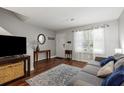 Bright living room featuring hardwood floors, neutral walls, and large window allowing natural light, creating an airy space at 507 Stinson Dr # E8, Charleston, SC 29407