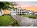 A beautiful two-story home showcasing a well-manicured lawn and a spacious driveway at 529 Dunswell Dr, Summerville, SC 29486