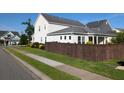 Exterior view of a home featuring a fenced yard, green grass and well-maintained surroundings at 558 Pendleton Dr, Moncks Corner, SC 29461