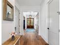 Bright foyer with hardwood floors, wood doors, and a decorative rug at 566 Wading Pl, Daniel Island, SC 29492