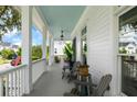 Spacious front porch with rocking chairs, a blue ceiling, and views of the neighborhood at 566 Wading Pl, Daniel Island, SC 29492