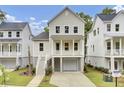 Charming two-story home with a quaint front porch, driveway, and manicured landscaping at 619 Du Bois Dr, Johns Island, SC 29455