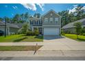 Inviting two-story house with a neatly maintained lawn and a convenient two-car garage in a Gathering-friendly neighborhood at 704 Kilarney Rd, Summerville, SC 29483