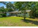 Attractive single-story home with a well-manicured lawn, mature trees, and a welcoming facade at 734 Waterloo St, Charleston, SC 29412