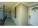 A cozy front porch featuring brick walls, decorative iron railing, and a white front door at 734 Waterloo St, Charleston, SC 29412