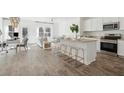 Open-concept kitchen flows into the living area, filled with natural light at 8712 Silver Perch Ln, North Charleston, SC 29420