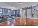 Spacious living area with hardwood floors, built-in shelving, and a cozy sectional sofa for comfortable living at 9024 Parlor Dr, Ladson, SC 29456