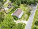 Birds eye view showcases a house with a long drive and beautiful trees on a sunny day at 93 Knights Ave, Walterboro, SC 29488