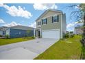Inviting two-story home with a well-maintained lawn, featuring a two-car garage and classic design elements at 1032 Peridote Way, Ladson, SC 29456