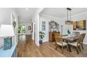 Bright dining room with hardwood floors, stylish lighting, and elegant decor at 104 Limpkin Ln, Summerville, SC 29483