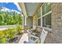 Cozy front porch featuring rocking chairs and brick detailing at 104 Limpkin Ln, Summerville, SC 29483