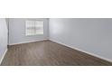Bedroom features new laminate flooring, neutral paint, and a large window at 107 Hickory Ln # C, Ladson, SC 29456