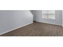 Bright living room features new laminate flooring, neutral paint, and a large window at 107 Hickory Ln # C, Ladson, SC 29456