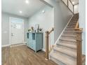 Inviting foyer with hardwood floors, staircase, and a blue accent cabinet for a modern feel at 109 Goose Rd, Summerville, SC 29483