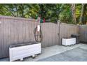 Backyard with gray fencing, planter boxes, and a built-in EV charger at 1126 Brigantine Dr, Charleston, SC 29412