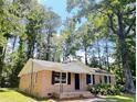 Charming single-story brick home with a manicured lawn and surrounded by lush trees at 114 Madison St, Walterboro, SC 29488