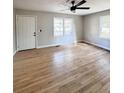 Bright living room boasts hardwood floors, large windows, and a modern ceiling fan at 114 Madison St, Walterboro, SC 29488