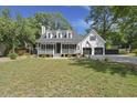 Charming home featuring a welcoming front porch, well-manicured lawn, and a convenient two-car garage at 1260 Old Whitesville Rd, Moncks Corner, SC 29461