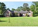 Lovely brick home with a well-kept lawn, highlighting its charming details and inviting curb appeal at 1457 Green Pond Hwy, Walterboro, SC 29488
