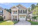 Inviting two-story home featuring a cozy front porch and attached one car garage at 153 Instructor Ct, Ladson, SC 29456