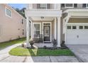 Close-up of the entry to a charming home with chairs and potted plants on the front porch at 153 Instructor Ct, Ladson, SC 29456