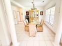 Elegant dining room with tiled floor, chandelier, and glass-topped table with seating at 1804 Bass Rd, Moncks Corner, SC 29461