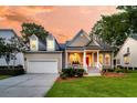Beautiful home showcasing a lovely porch, manicured lawn, and an attached two-car garage at 1809 Two Cedar Way, Mount Pleasant, SC 29466
