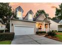 Spacious two-car garage complementing this charming home with a bright red front door and inviting porch at 1809 Two Cedar Way, Mount Pleasant, SC 29466