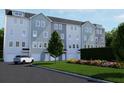 Townhome community featuring gray and white siding, attached garages, and landscaped grounds at 2161 W Jimtown Dr # 101, North Charleston, SC 29405