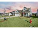 Attractive home with a well-maintained lawn, covered front porch, long driveway, and classic design at 274 Tupelo Lake Dr, Summerville, SC 29486