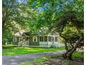 Picturesque view of a quaint home nestled among lush trees, showcasing its inviting curb appeal and serene surroundings at 286 Mallard Lake Rd, Dorchester, SC 29437