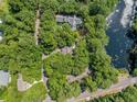 Aerial view of a beautiful home surrounded by mature trees, offering a private retreat near a tranquil pond at 2938 Old Drake Dr, Seabrook Island, SC 29455