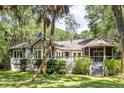 This home boasts a spacious back deck and screened porch, perfect for relaxing and enjoying the lush greenery at 2938 Old Drake Dr, Seabrook Island, SC 29455