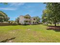 Expansive backyard showcasing a lush green lawn and mature trees at 309 Pinopolis Park Dr, Moncks Corner, SC 29461