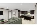 Open-concept living area with a comfortable sofa flowing into a modern kitchen with a center island at 313 Marion Rd, Dorchester, SC 29437