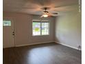Bright living room featuring hardwood floors, a ceiling fan, and a large window for plenty of natural light at 352 Oxford Rd, Ladson, SC 29456