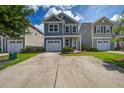 Charming two-story home with a well-manicured lawn, long driveway, and an attached garage at 3903 Poplar Grove Pl, Summerville, SC 29483