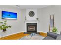 Charming living room featuring a cozy fireplace, hardwood floors, and contemporary decor for a comfortable space at 4030 Babbitt St, Charleston, SC 29414